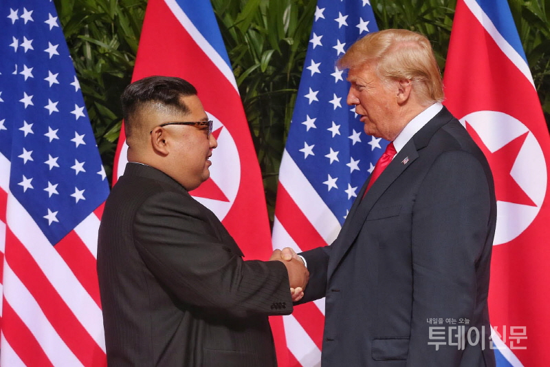 도널드 트럼프 미국 대통령과 북한 김정은 국무위원장이 지난 12일 오전 북미정상회담이 열린 싱가포르 센토사섬 카펠라 호텔에서 만나 악수하고 있다. ⓒ뉴시스