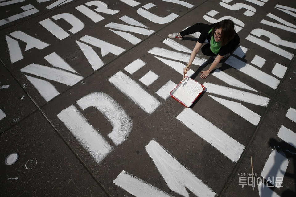 지난 3월 8일, 멕시코시티 소칼로 광장 바닥에 여성폭력 희생자들의 이름을 새기고 있는 여성 ⓒ뉴시스