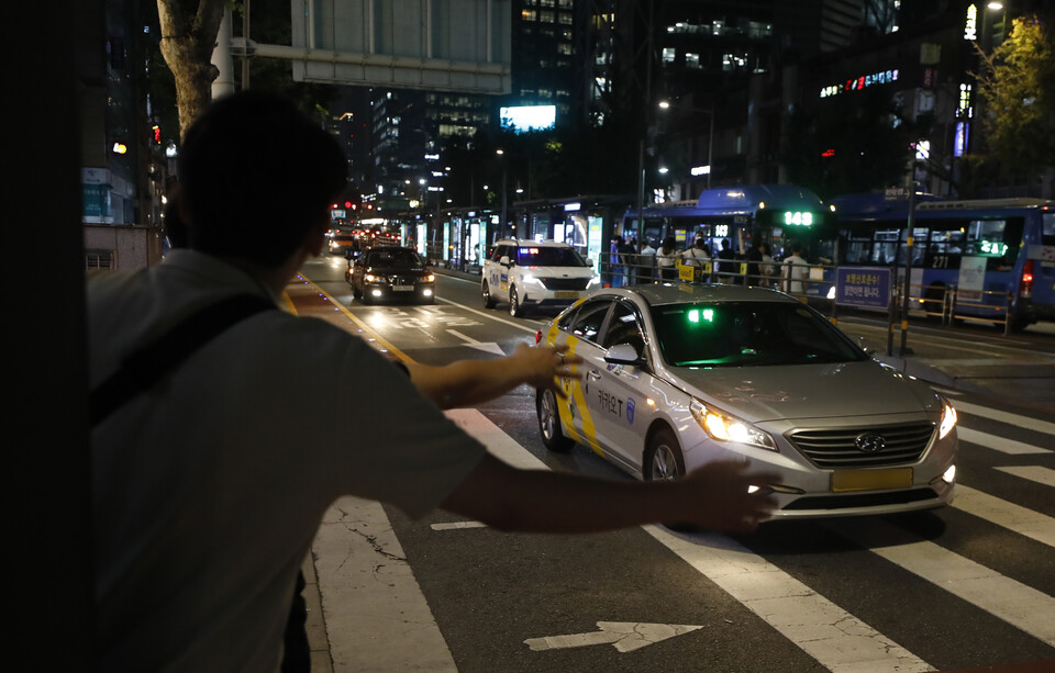 서울 도심에서 시민들이 택시를 잡는 모습. [사진제공=뉴시스]