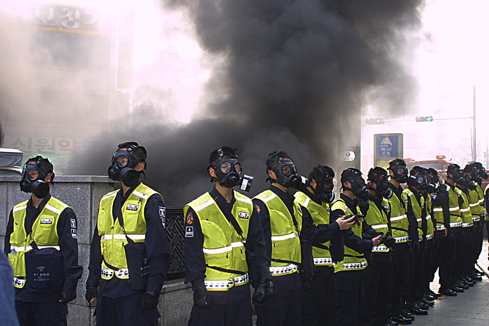 화재 현장을 지키는 경찰인력들. 모두 방독면을 착용하고 있다. [사진제공=대구지하철참사희생자대책위]