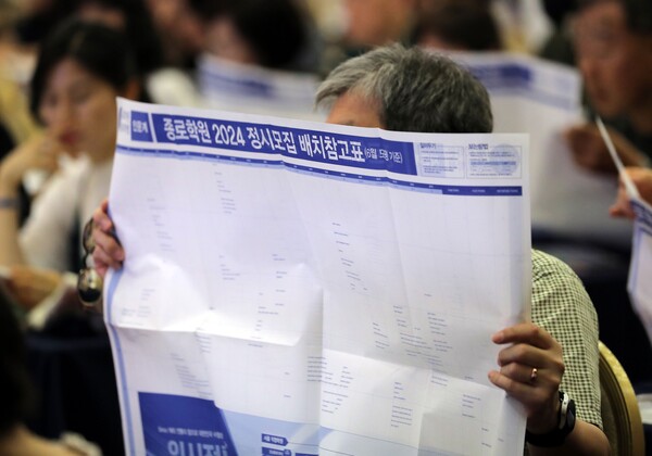 수험생 학부모들이 지난 7월 서울 광진구 세종대학교 광개토관 컨벤션홀에서 열린 '종로학원 2024대입 수시정시 합격 예상 점수 공개 및 수험생 지원전략 설명회'애서 배치표를 살펴보고 있다. [사진제공=뉴시스]